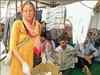 German woman and son clear litter in Rishikesh