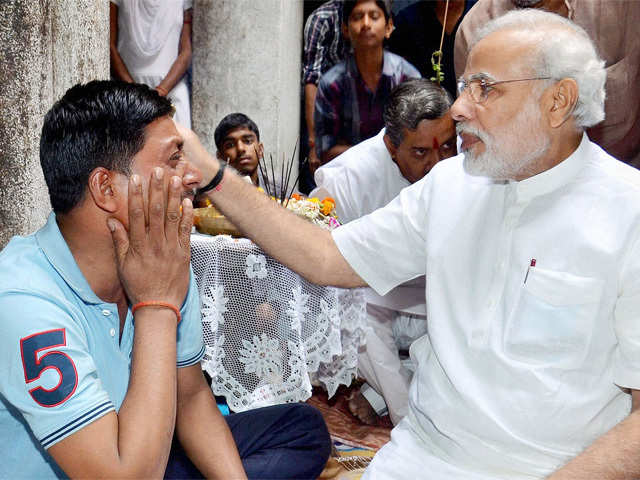 Narendra Modi consoles family member of a recent serial bomb blast victim