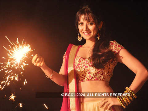 Bollywood actor Tanisha Singh poses with diyas and crackers during a photo  shoot for Pre-Diwali celebrations in Mumbai