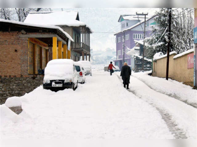 People walking in snow after overnight snowfall in Bhaderwah