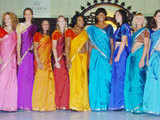 Tennis players pose wearing a saree