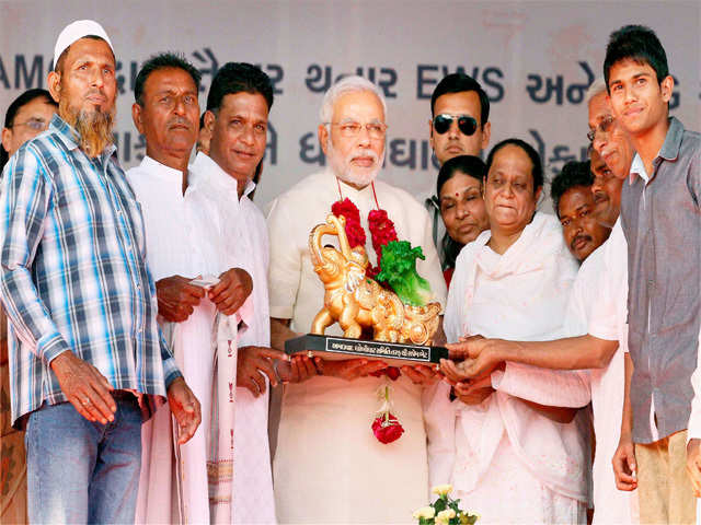 Narendra Modi receiving a memento from washermen in Ahmedabad