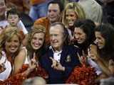 Former President George Bush with cheerleaders