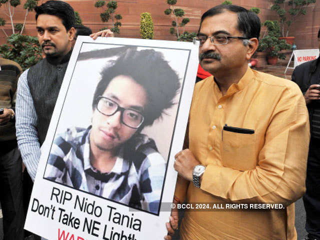 BJP members holding a poster of Arunachal Pradesh student  Nido