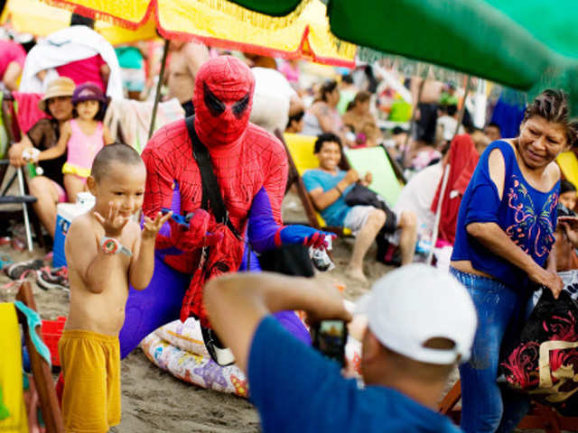 A vendor wearing an Spiderman costume pose in Chhorilos