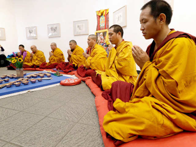 Buddhist monks pray during  opening ceremony of  Sacred Arts Tour at The ArtsCenter