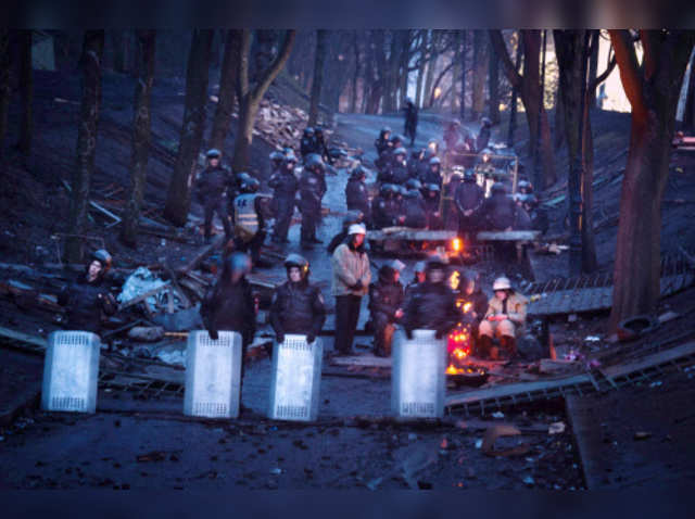 Riot police stand guard near a barricade in Kiev