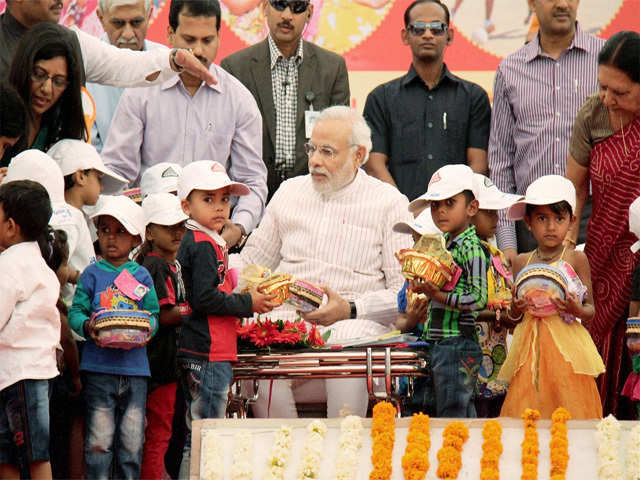 Narendra Modi with children during a Mahila Sammelan in Vyara
