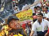 Filipino farmers burn an effigy of President Gloria Arroyo