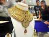 Gold off 4-month highs, crude prices fall