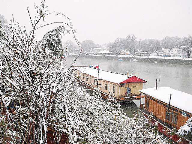 Rooftop of house boats laden with snow