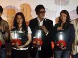 Bollywood actors hold solar lanterns during a news conference
