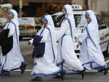 Catholic nuns cross a Sydney street