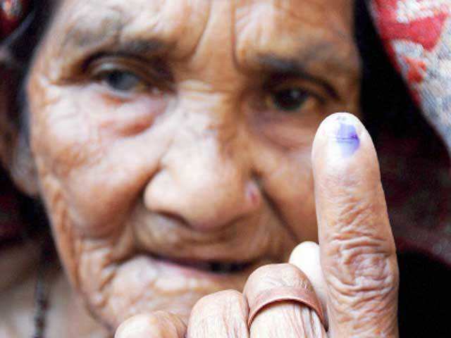 Elderly lady showing her ink-marked finger