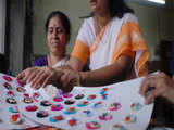Blind women giving final touches of Rakhis