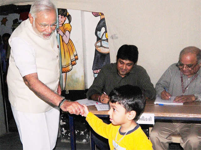 Modi shakes hands with a boy