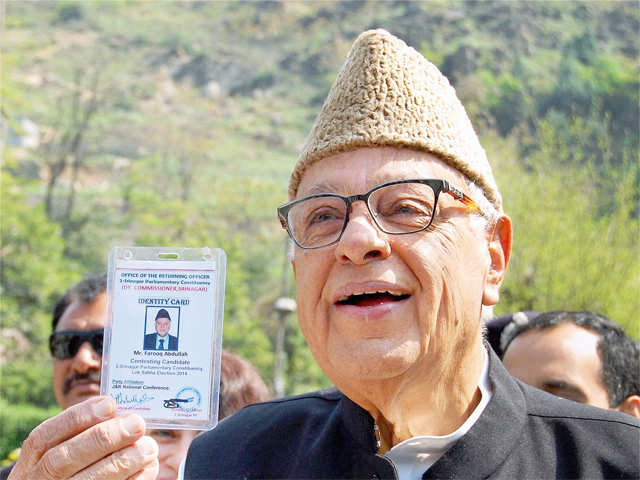 Farooq Abdullah shows his voter identity card