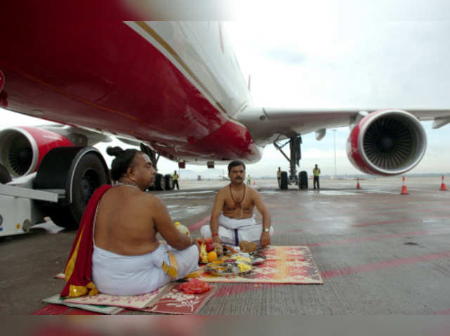 Priest offering prayers under Kingfisher airlines