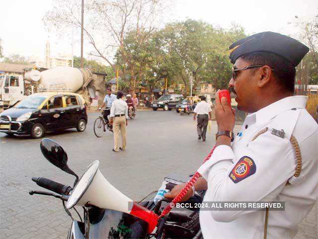 Megaphone wielding cops tell motorists to wear helmets