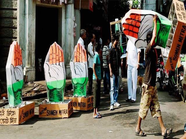 A Congress worker carries the party insignia