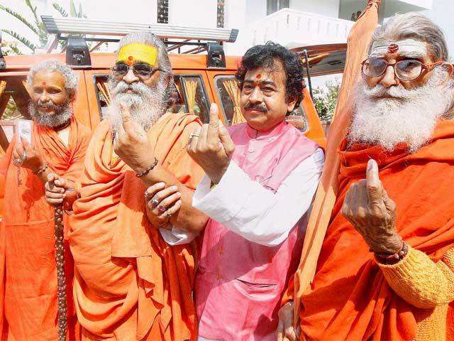 Sadhus show their inked fingers