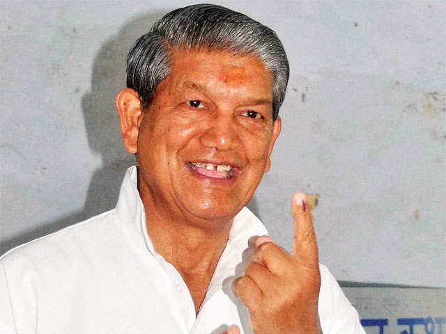 Uttarakhand CM Harish Rawat shows his inked finger after casting vote