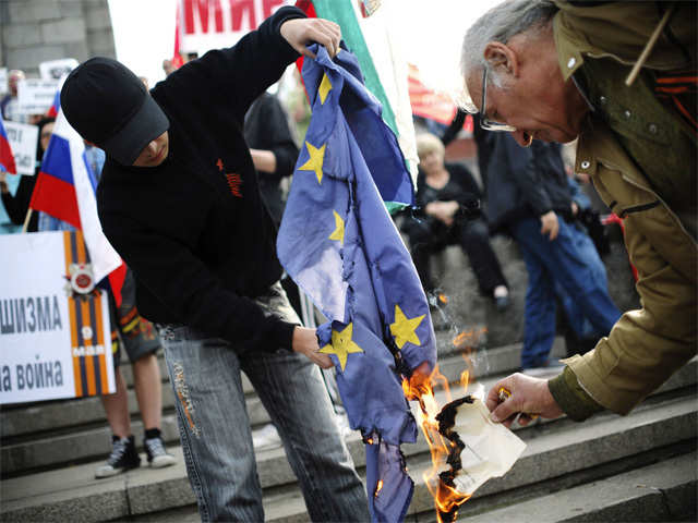 Demonstrators setting fire to the EU flag in Sofia