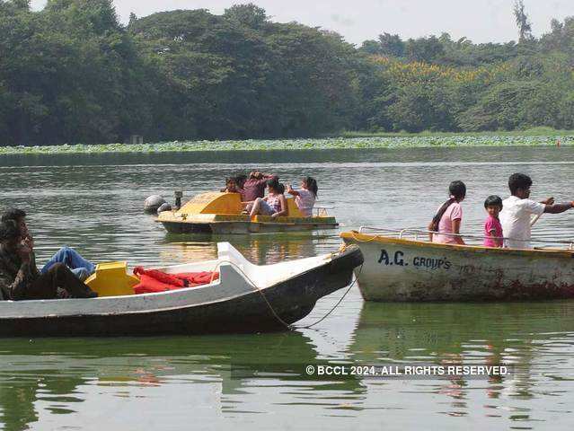 Tourists enjoy boating in Karanji Lake, Mysore