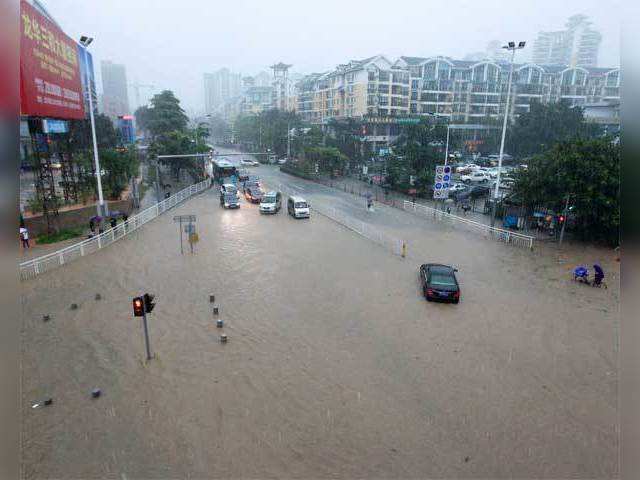 Cars moving through heavy flooding