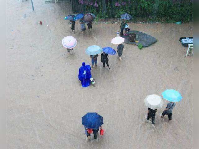 Pedestrians wade through