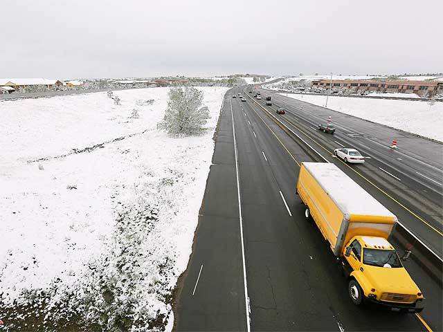 Commuters pass fresh snow in Colorado
