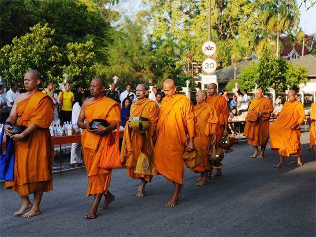 Thai Buddhist monks receive food offerings on Visakha Bucha Day in Thailand