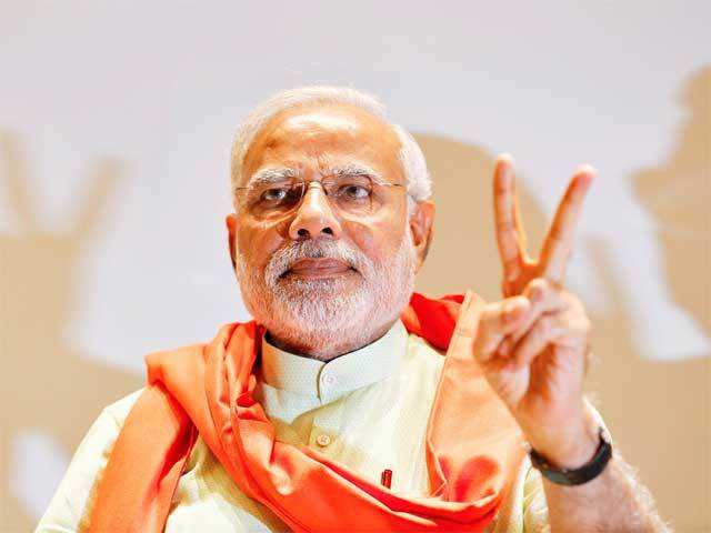 Narendra Modi gestures upon his arrival in Gandhinagar
