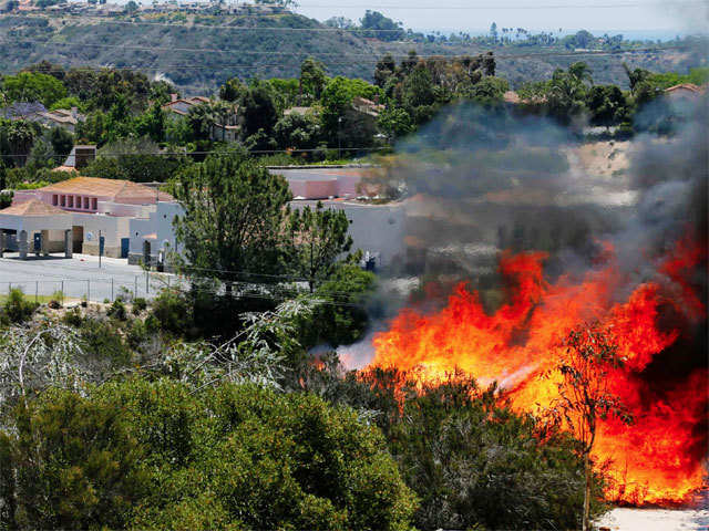 A wildfire burns near an evacuated school in Carlsbad