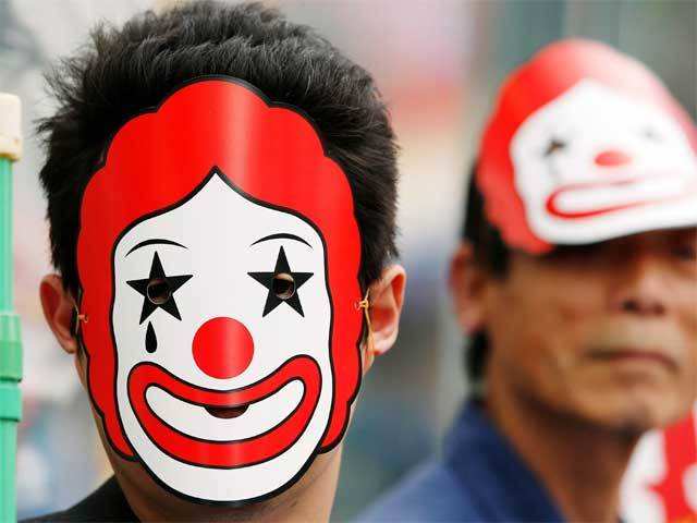 Workers wear McD mascot to protest for higher wages