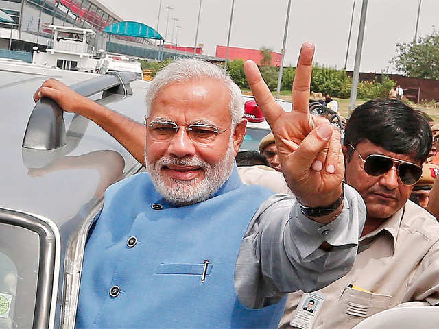 Narendra Modi gestures to his supporters in New Delhi