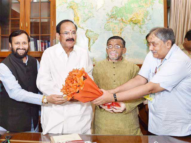 M Venkaiah Naidu accepts a bouquet in new office