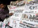 Vendor arranges newspapers