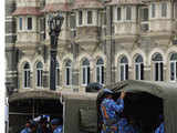 Policemen board a truck to leave the area of Taj Mahal Hotel