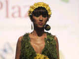 A model showcases a creation made of leaves and flowers