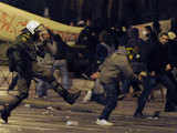 Greek anti-riot police kicks protestor
