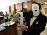 Masked Greenpeace activist serves water