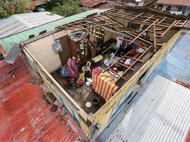 Woman collects belongings inside a home