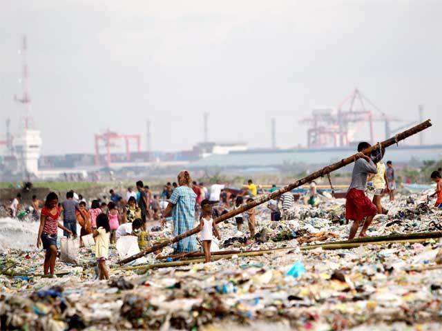 Filipinos collect reusable materials from debris