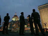 Policemen stand in front of Taj hotel