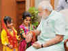Women, children tie rakhi on Prime Minister Narendra Modi's wrist