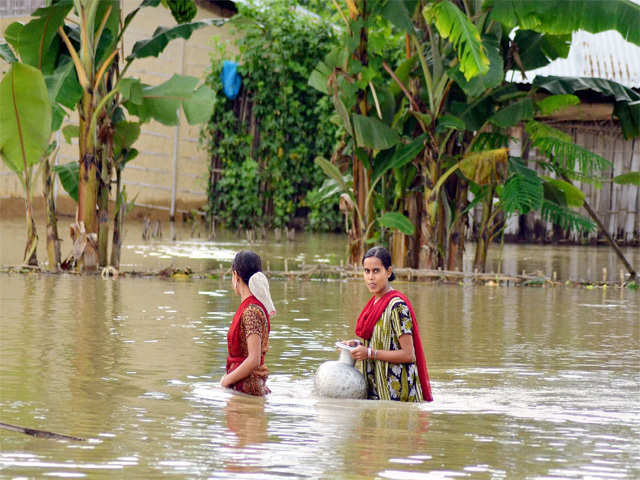 Girls walk in flood affected area