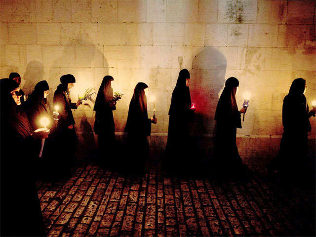 Orthodox nuns take part in a procession to bring the icon of the Virgin Mary