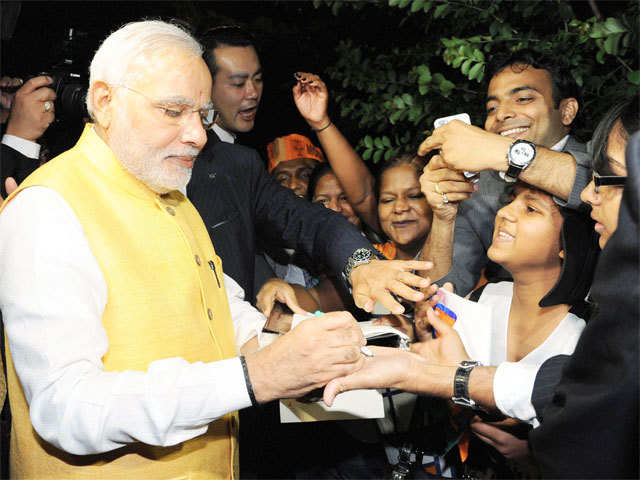 PM Narendra Modi signing autographs