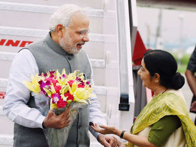 Narendra Modi being greeted by Sushma Swaraj